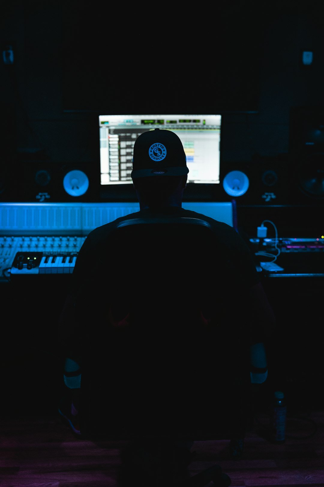 a-man-sitting-in-front-of-a-mixing-desk-85eaxrsor60