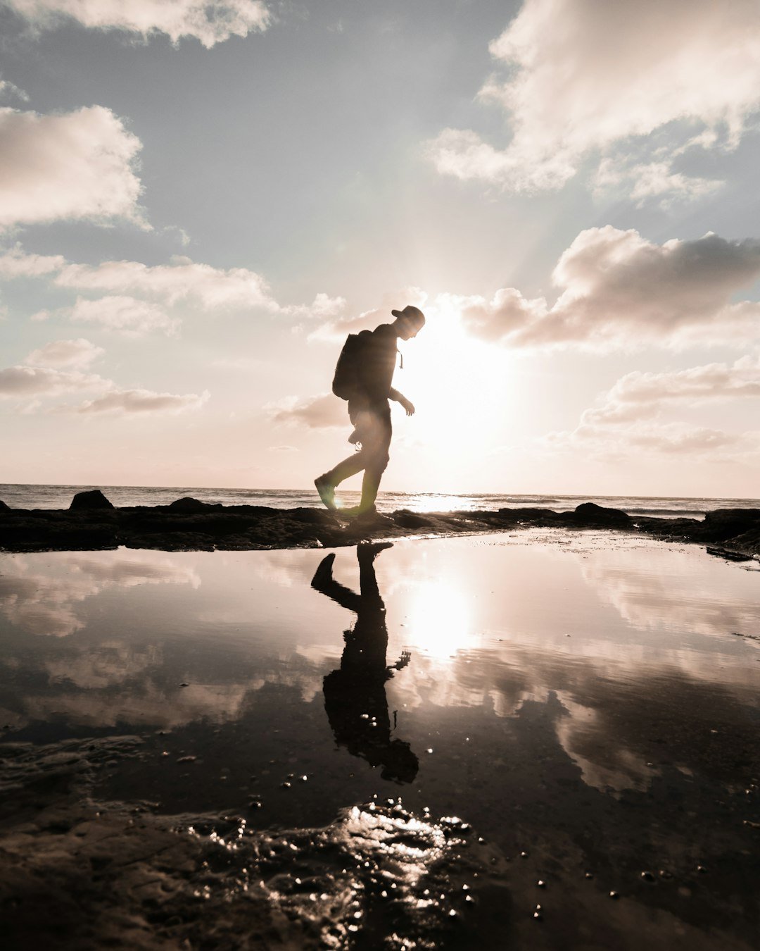 man-in-black-shorts-standing-on-water-during-daytime-0mzirphrpka